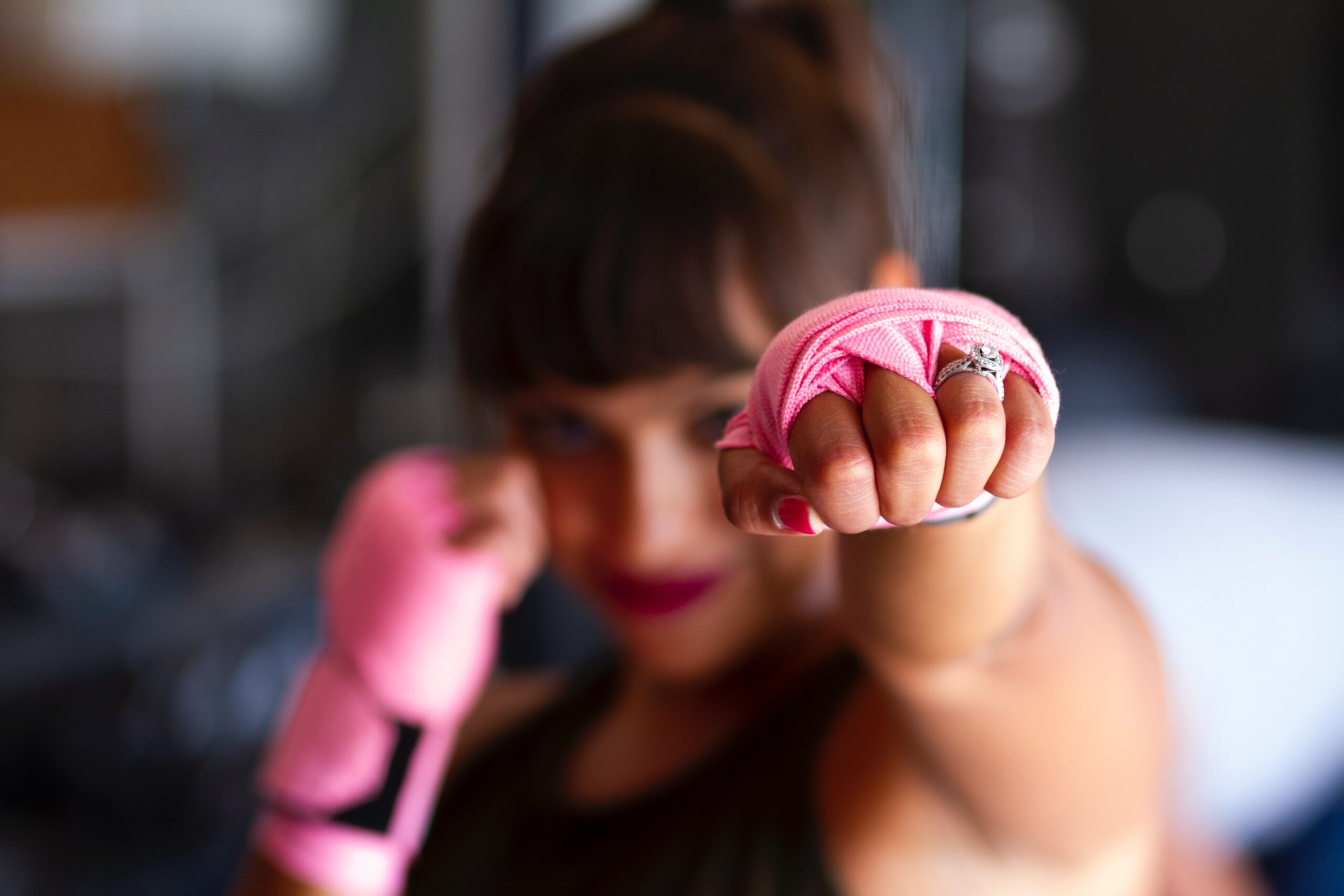 Women with pink boxing wraps on hands.