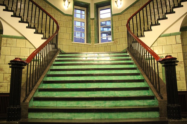 Green and brown staircase with two banisters.