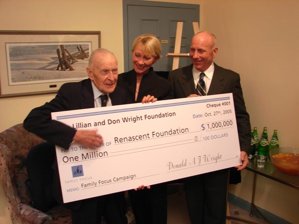 Group of three people holding cheque at Don Wright Event