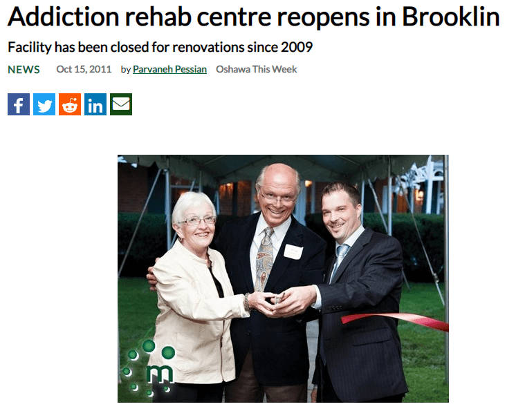Three people cutting the ribbon for the Sullivan Treatment Centre reopening.