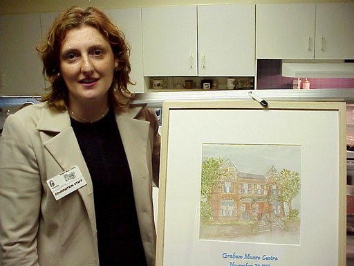 Joanne Steel holding print at Munro opening party.