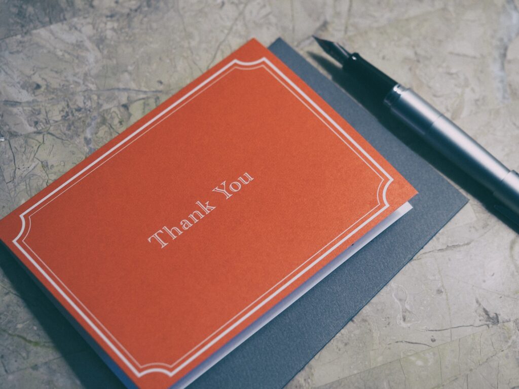 Thank you card, envelope and pen.