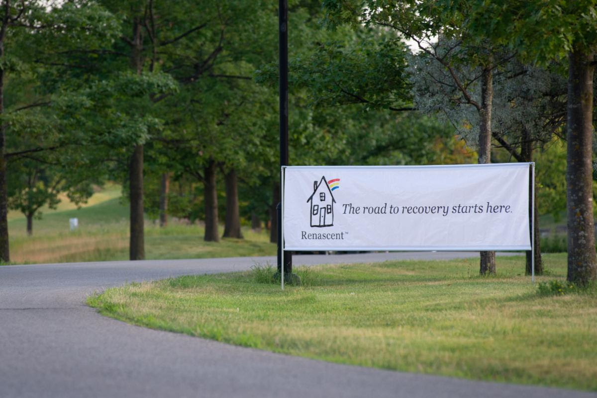 Recovery Shot banner on lawn by trees.