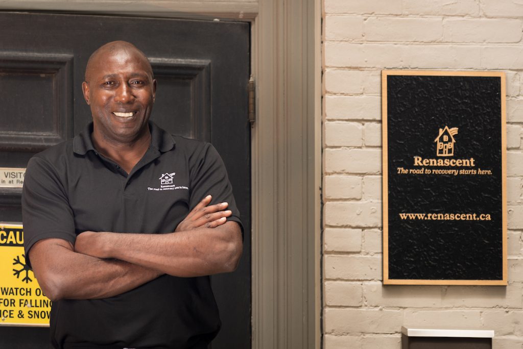 Isaiah Gayle stands at Renascent's front door.