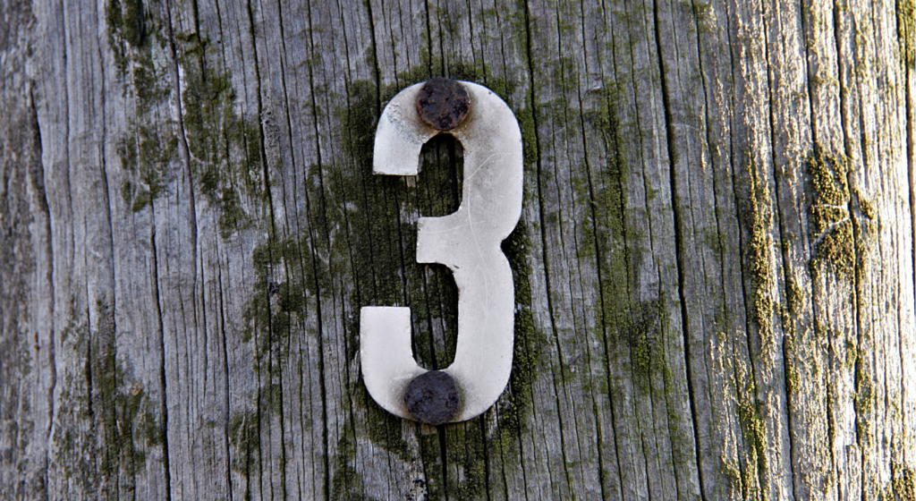 The number 3 on a fence post