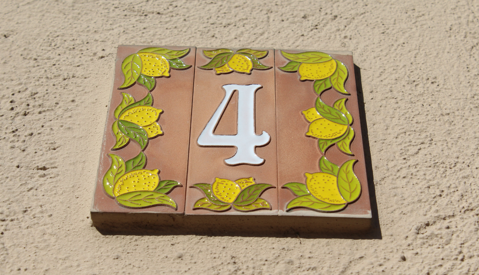 Decorative brick with the number '4' and lemons.