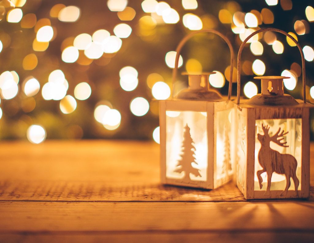 Two lanterns with twinkle lights in the background