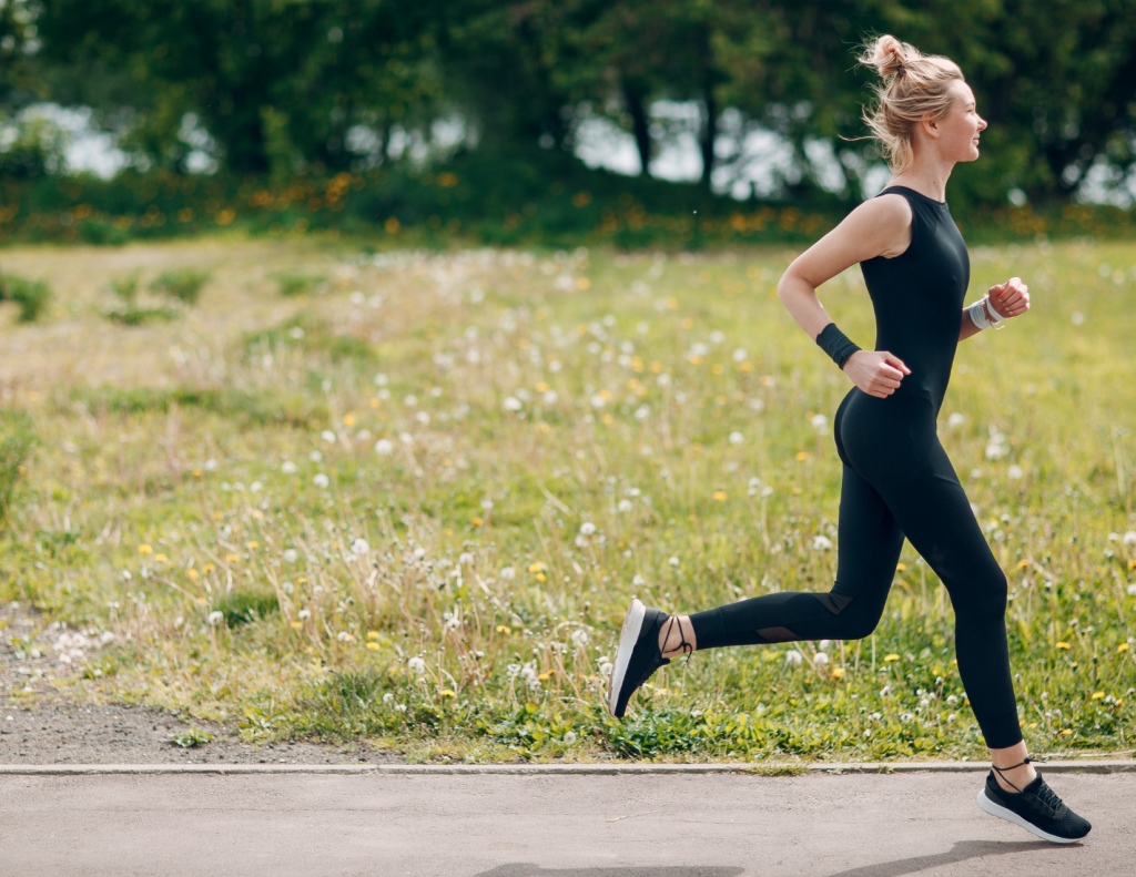 Woman running on path by park