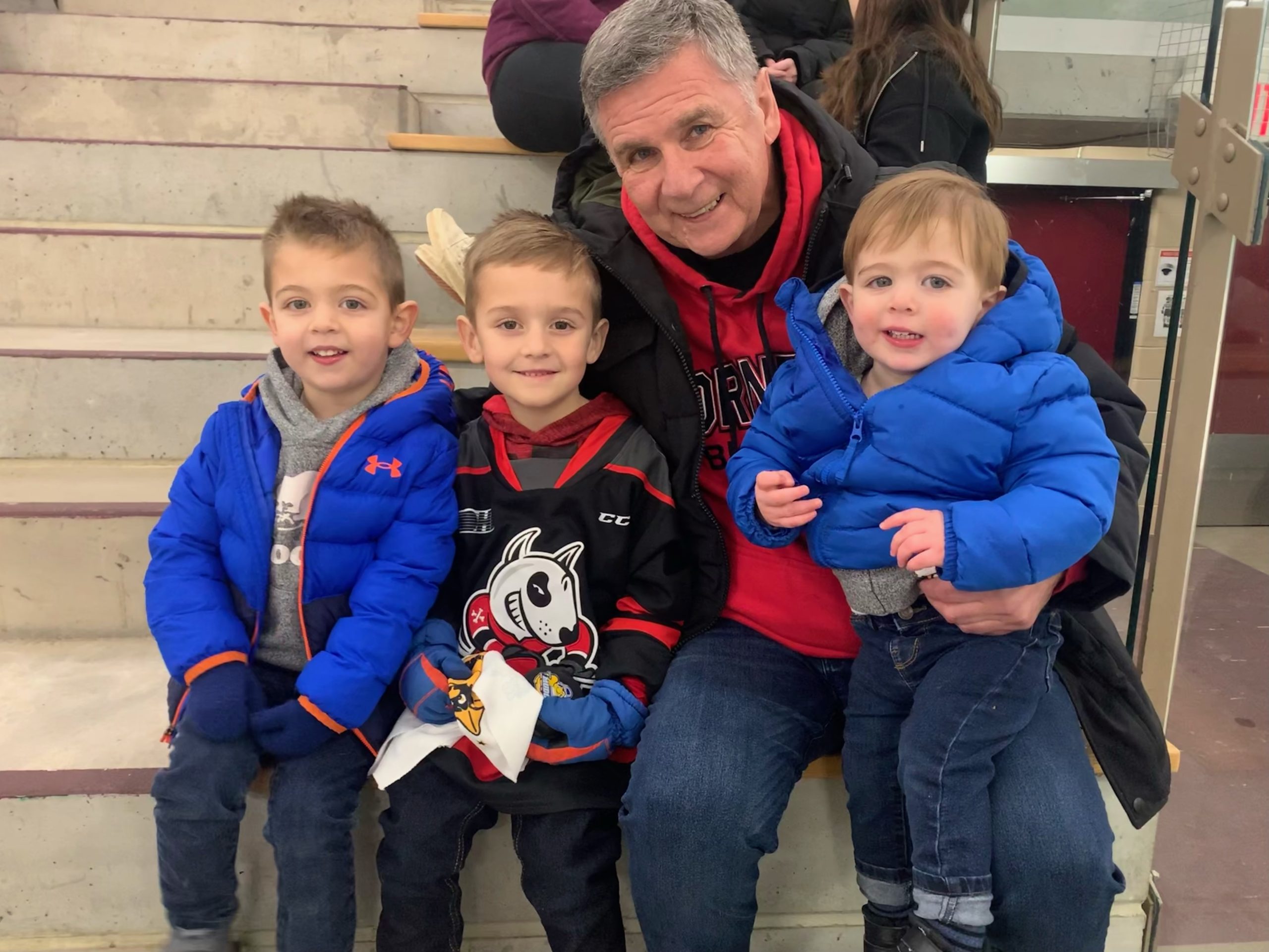 Terry and his grand children at a hockey game.