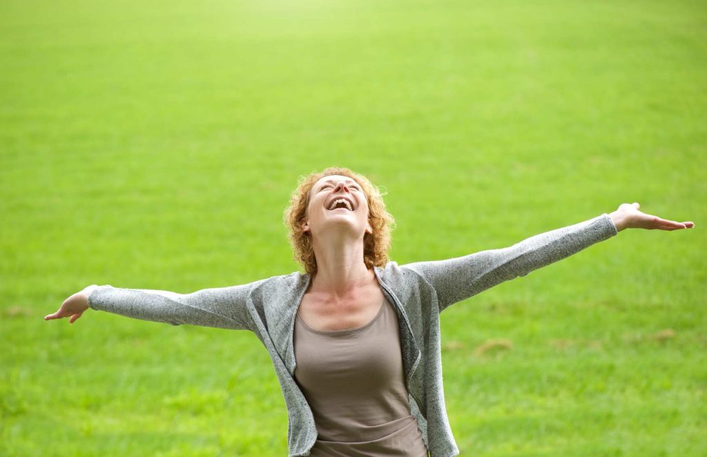 Happy woman with hands outstretched