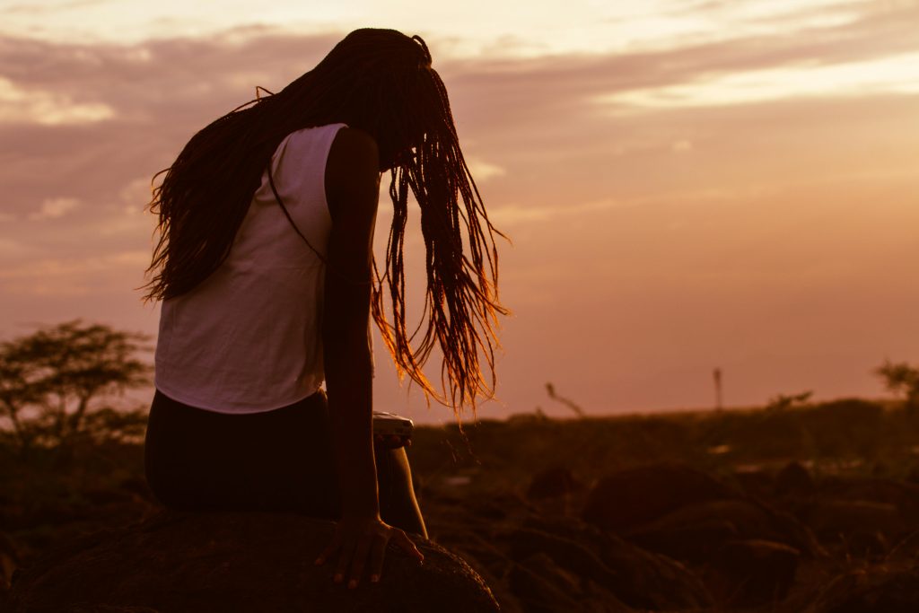 Woman sitting and watching the sunset