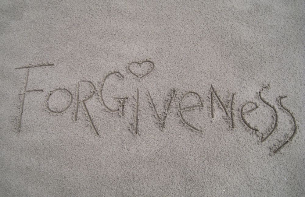 Forgiveness written in sand