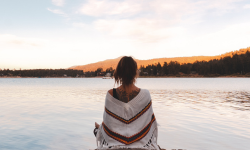 Woman Sitting by Lake