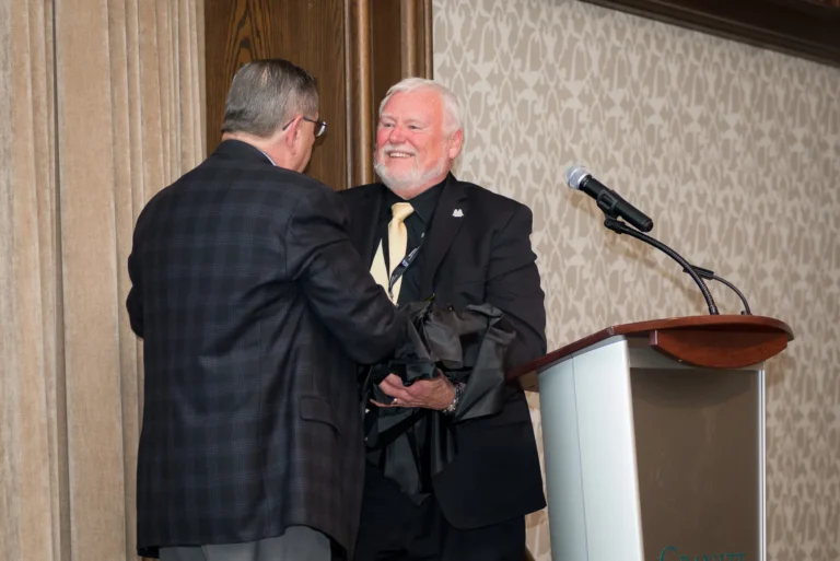 Ed Harding (left) presenting Dennis James (right) with the Ed & Bobby Yielding Award at the 2017 Guardian Angel Luncheon.