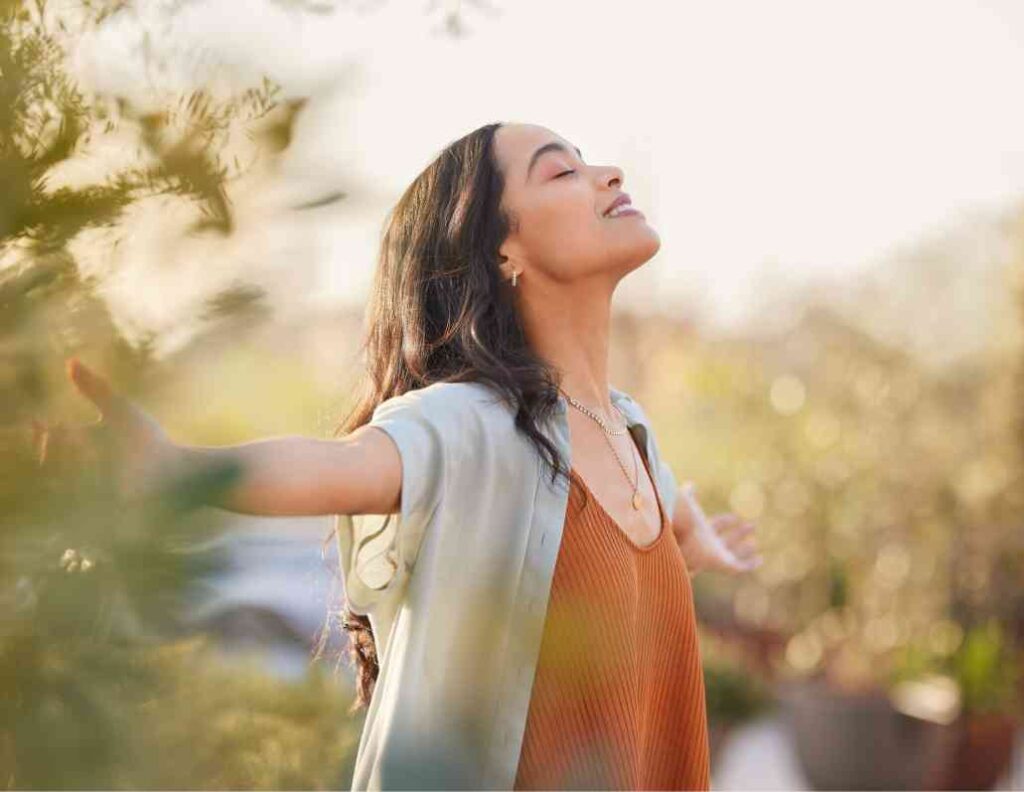 Woman standing with hands outstretched